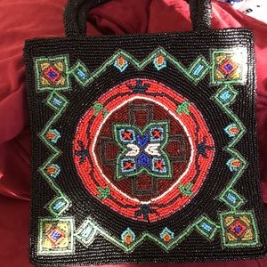 A Christiana beaded purse 7by7 inches. Red /black green/blue geometric floral